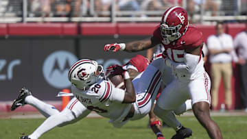 Oct 12, 2024; Tuscaloosa, Alabama, USA;  Alabama Crimson Tide defensive back Malachi Moore (13) and Alabama Crimson Tide linebacker Justin Jefferson (15) combine to tackle South Carolina Gamecocks tight end Michael Smith (20) at Bryant-Denny Stadium. Mandatory Credit: Gary Cosby Jr.-Imagn Images
