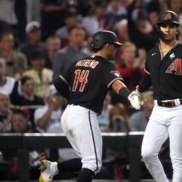 Arizona Diamondbacks center fielder Alek Thomas (5) congratulates catcher Gabriel Moreno (14) after scoring a run against the Texas Rangers during the fourth inning in Game 4 of the 2023 World Series at Chase Field in Phoenix, AZ. The DBacks lost to the Rangers 11-7, putting the Ranger at 3-1 in the World Series.
