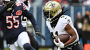 Oct 19, 2025; Chicago, Illinois, USA; New Orleans Saints running back Alvin Kamara (41) rushes the ball against the Chicago Bears during the second half at Soldier Field. Mandatory Credit: Mike Dinovo-Imagn Images