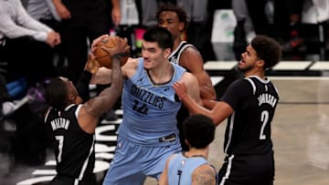 Nov 4, 2024; Brooklyn, New York, USA; Memphis Grizzlies center Zach Edey (14) fights for a rebound against Brooklyn Nets guard Shake Milton (7) and center Nic Claxton (33) and forward Cameron Johnson (2) during the second quarter at Barclays Center. Mandatory Credit: Brad Penner-Imagn Images