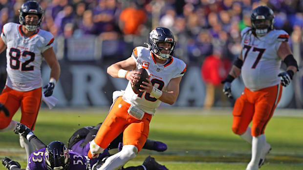 Nov 3, 2024; Baltimore, Maryland, USA; Denver Broncos quarterback Bo Nix (10) runs for a gain in the second quarter against t
