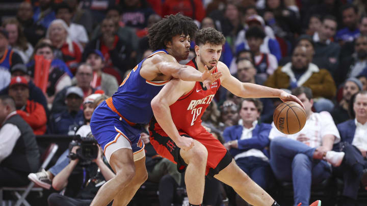 Feb 12, 2024; Houston, Texas, USA; Houston Rockets center Alperen Sengun (28) controls the ball as New York Knicks center Jericho Sims (45) defends during the third quarter at Toyota Center. Mandatory Credit: Troy Taormina-USA TODAY Sports