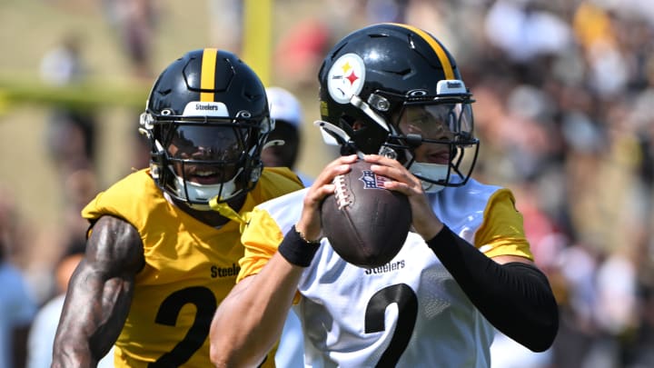 Jul 28, 2024; Latrobe, PA, USA; Pittsburgh Steelers quarterback Justin Fields (2) is pressured by safety DeShon Elliott (25) during training camp at Saint Vincent College. Mandatory Credit: Barry Reeger-USA TODAY Sports