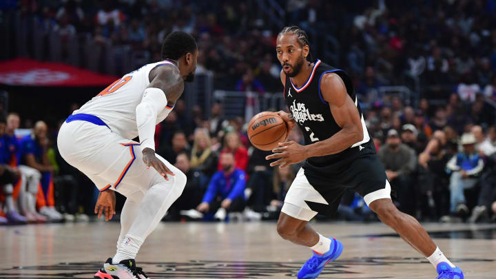 Dec 16, 2023; Los Angeles, California, USA; Los Angeles Clippers forward Kawhi Leonard (2) moves the ball against New York Knicks forward Julius Randle (30) during the first half at Crypto.com Arena.