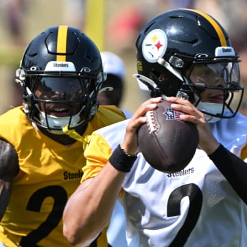 Jul 28, 2024; Latrobe, PA, USA; Pittsburgh Steelers quarterback Justin Fields (2) is pressured by safety DeShon Elliott (25) during training camp at Saint Vincent College. Mandatory Credit: Barry Reeger-USA TODAY Sports