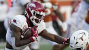 Arkansas Razorbacks quarterback KJ Jackson (7) runs from the pocket while defended by Texas Longhorns defensive back Jelani McDonald (4) during the second half at Darrell K Royal-Texas Memorial Stadium.