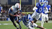 Nov 15, 2025; Durham, North Carolina, USA;  Virginia Cavaliers wide receiver Trell Harris (11) takes a hit from Duke Blue Devils saftey Ma'khi Jones (26) during the third quarter at Wallace Wade Stadium. Mandatory Credit: Zachary Taft-Imagn Images