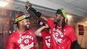Sep 28, 2025; Milwaukee, Wisconsin, USA;  Cincinnati Reds shortstop Elly De La Cruz (right) celebrates after the Reds clinched a wild card spot after the game against the Milwaukee Brewers at American Family Field. Mandatory Credit: Benny Sieu-Imagn Images