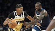 Nov 19, 2025; Minneapolis, Minnesota, USA; Washington Wizards guard Bilal Coulibaly (0) dribble the ball as Minnesota Timberwolves forward Julius Randle (30) plays defense in the second half at Target Center. Mandatory Credit: Jesse Johnson-Imagn Images