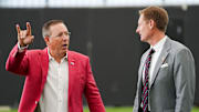 University of Cincinnati head football coach Scott Satterfield, left, and athletic director John Cunningham, right, have a conversation, Wednesday, June 11, 2025, at Sheakley Indoor Performance Center in Cincinnati.