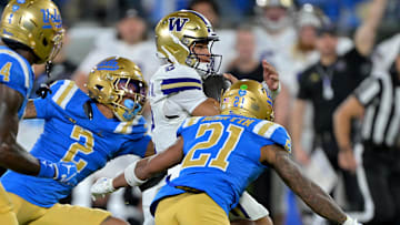 Nov 22, 2025; Pasadena, California, USA;  Washington Huskies quarterback Demond Williams Jr. (2) gets by UCLA Bruins defensive back Andre Jordan Jr. (2) and defensive back Cole Martin (21) as he runs for a touchdown during the first half at the Rose Bowl. Mandatory Credit: Jayne Kamin-Oncea-Imagn Images