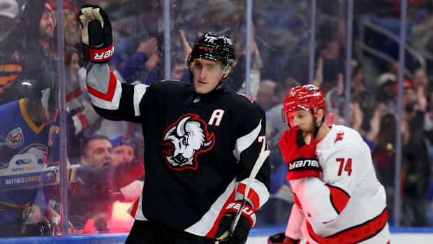 Hockey player in black uniform celebrates a goal