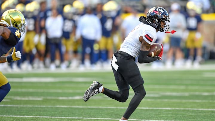 Sep 7, 2024; South Bend, Indiana, USA; Northern Illinois Huskies cornerback Amariyun Knighten (5) runs back an interception in the fourth quarter against the Notre Dame Fighting Irish at Notre Dame Stadium. Mandatory Credit: Matt Cashore-Imagn Images