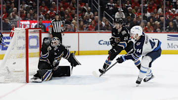 Feb 1, 2025; Washington, District of Columbia, USA; Winnipeg Jets defenseman Josh Morrissey (44) scores the game winning goal in overtime on Washington Capitals goaltender Logan Thompson (48) as Capitals center Connor McMichael (24) defends at Capital One Arena. Mandatory Credit: Geoff Burke-Imagn Images