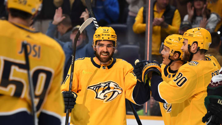 Nov 11, 2023; Nashville, Tennessee, USA; Nashville Predators defenseman Dante Fabbro (57) is congratulated by teammates after a goal during the first period against the Arizona Coyotes at Bridgestone Arena. Mandatory Credit: Christopher Hanewinckel-USA TODAY Sports