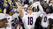 Nov 28, 2025; Tempe, Arizona, USA; Arizona Wildcats wide receiver Brandon Phelps (18) celebrates with the Territorial Cup trophy after defeating the Arizona State Sun Devils in the 99th Territorial Cup at Mountain America Stadium. Mandatory Credit: Mark J. Rebilas-Imagn Images