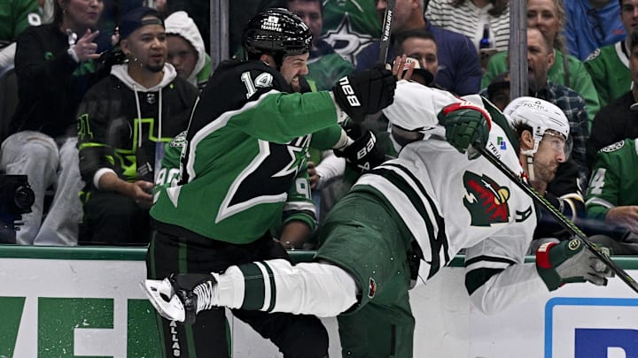 Apr 28, 2026; Dallas, Texas, USA; Dallas Stars left wing Jamie Benn (14) checks Minnesota Wild left wing Marcus Foligno (17) during the second period in game five of the first round of the 2026 Stanley Cup Playoffs at American Airlines Center. Mandatory Credit: Jerome Miron-Imagn Images