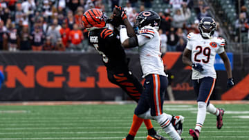 Cincinnati Bengals wide receiver Tee Higgins (5) catches a pass as Chicago Bears defensive back Jaquan Brisker (9) defends in the fourth quarter of the NFL football game between Chicago Bears and Cincinnati Bengals at Paycor Stadium in Cincinnati on Nov. 2, 2025.