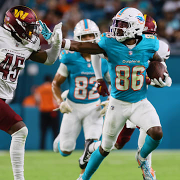 Miami Dolphins wide receiver Braylon Sanders (86) stiff-arms Washington Commanders safety Dominique Hampton (45) during the third quarter of a preseason game at Hard Rock Stadium. 