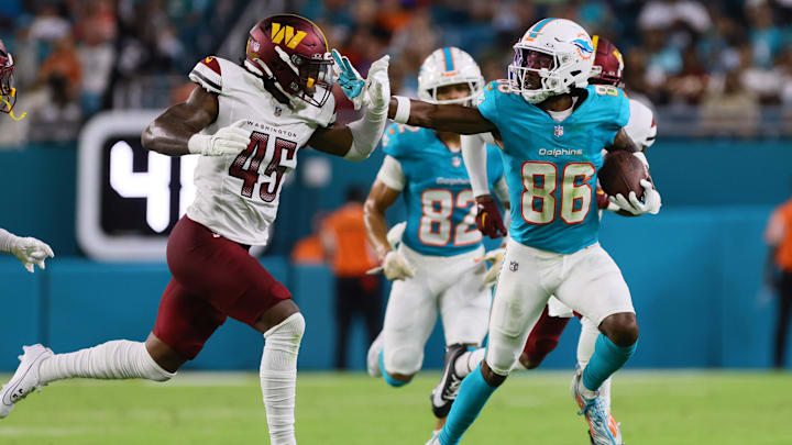 Miami Dolphins wide receiver Braylon Sanders (86) stiff-arms Washington Commanders safety Dominique Hampton (45) during the third quarter of a preseason game at Hard Rock Stadium. 