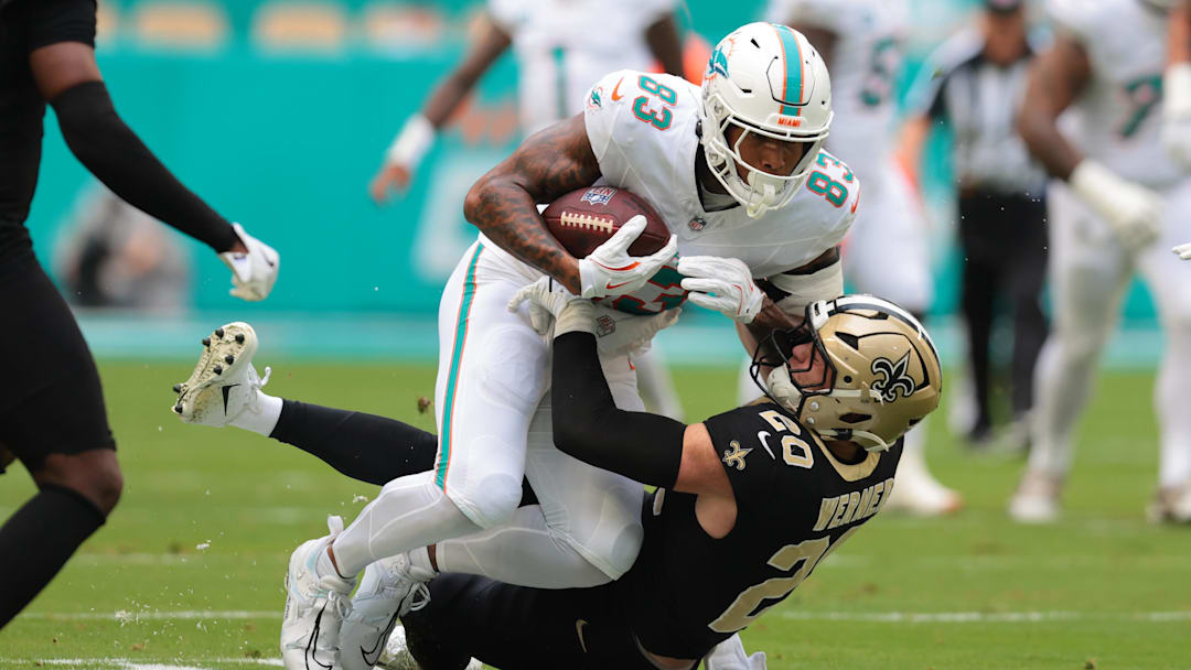 Miami Dolphins tight end Darren Waller (83) is tackled by New Orleans Saints linebacker Pete Werner (20) during the first half at Hard Rock Stadium.