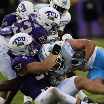 The TCU defense swarms the Long Island ballcarrier late in the game. 