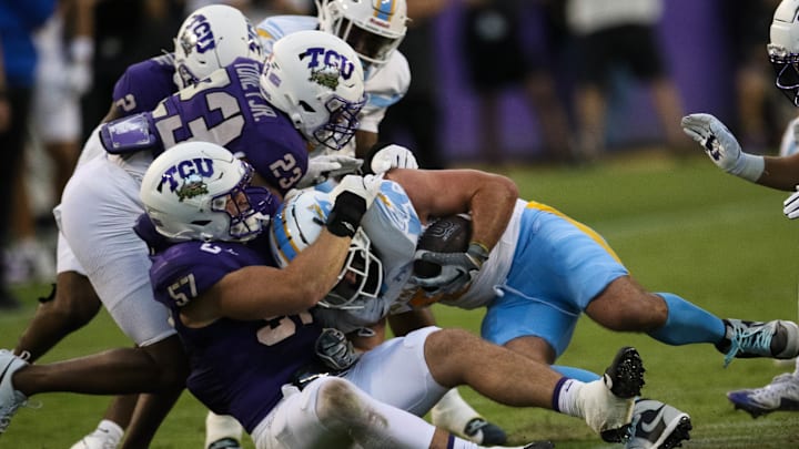 The TCU defense swarms the Long Island ballcarrier late in the game. 