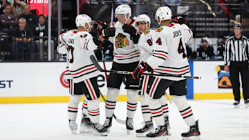 Oct 8, 2024; Salt Lake City, Utah, USA; The Chicago Blackhawks celebrate a goal by Chicago Blackhawks defenseman Alex Vlasic (center) against the Utah Hockey Club during the third period at Delta Center. Mandatory Credit: Rob Gray-Imagn Images