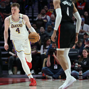 Apr 13, 2025; Portland, Oregon, USA: Los Angeles Lakers guard Dalton Knecht (4) brings the ball up the court against the Portland Trail Blazers in the second half at Moda Center. Mandatory Credit: Jaime Valdez-Imagn Images