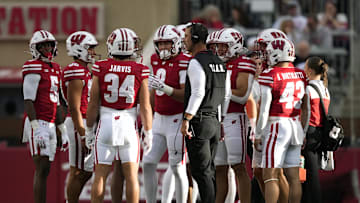 Sep 6, 2025; Madison, Wisconsin, USA;  Wisconsin Badgers head coach Luke Fickell talks with his team during a timeout against the Middle Tennessee Blue Raiders during the second half at Camp Randall Stadium. Mandatory Credit: Kayla Wolf-Imagn Images