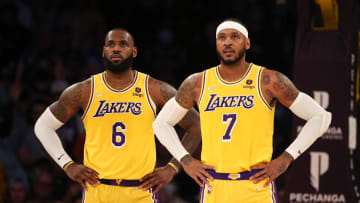 Nov 26, 2021; Los Angeles, California, USA; Los Angeles Lakers forward LeBron James (6) and forward Carmelo Anthony (7) stand on the court during the game against the Sacramento Kings at Staples Center. The Kings wins 141-137 in the triple-overtime. Mandatory Credit: Kiyoshi Mio-USA TODAY Sports