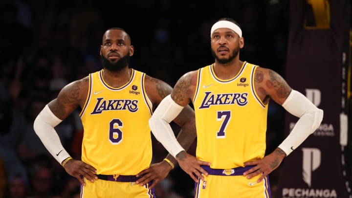 Nov 26, 2021; Los Angeles, California, USA; Los Angeles Lakers forward LeBron James (6) and forward Carmelo Anthony (7) stand on the court during the game against the Sacramento Kings at Staples Center. The Kings wins 141-137 in the triple-overtime. Mandatory Credit: Kiyoshi Mio-USA TODAY Sports