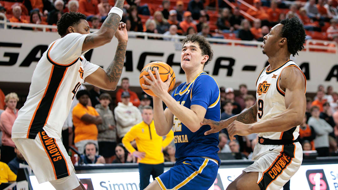 Feb 24, 2026; Stillwater, Oklahoma, USA; West Virginia Mountaineers forward Treysen Eaglestaff (52) drives to the basket around Oklahoma State Cowboys guard Christian Coleman (4) during the second half at Gallagher-Iba Arena. Mandatory Credit: William Purnell-Imagn Images Feb 24, 2026; Stillwater, Oklahoma, USA; West Virginia Mountaineers forward Treysen Eaglestaff (52) drives to the basket around Oklahoma State Cowboys guard Christian Coleman (4) during the second half at Gallagher-Iba Arena. Mandatory Credit: William Purnell-Imagn Images