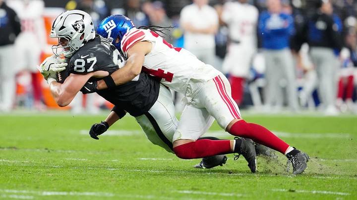 Dec 28, 2025; Paradise, Nevada, USA; Las Vegas Raiders tight end Michael Mayer (87) is tackled by New York Giants safety Dane Belton (24) in the third quarter at Allegiant Stadium. Mandatory Credit: Stephen R. Sylvanie-Imagn Images