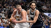 Jan 12, 2025; Dallas, Texas, USA; Denver Nuggets center Nikola Jokic (15) grabs a rebound in front of Dallas Mavericks center Dereck Lively II (2) during the second quarter at the American Airlines Center. Mandatory Credit: Jerome Miron-Imagn Images