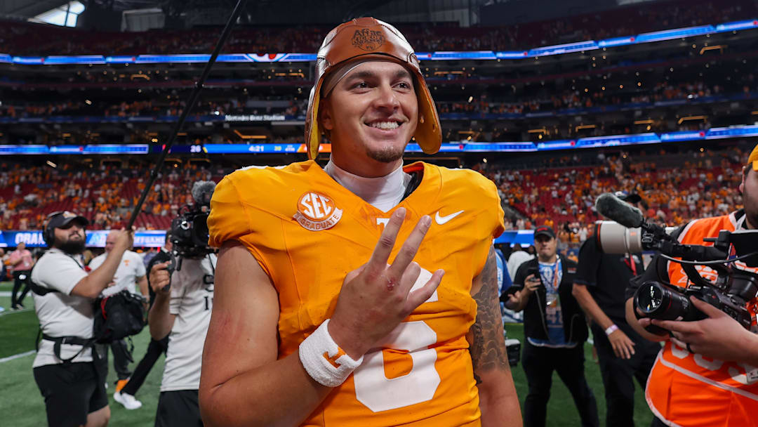 Aug 30, 2025; Atlanta, Georgia, USA; Tennessee Volunteers quarterback Joey Aguilar (6) celebrates with the old leather helmet after a victory against the Syracuse Orange at Mercedes-Benz Stadium. Mandatory Credit: Brett Davis-Imagn Images