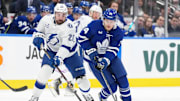 Jan 20, 2025; Toronto, Ontario, CAN; Toronto Maple Leafs center Bobby McMann (74) skates with the puck as Tampa Bay Lightning left wing Nick Paul (20) gives chase during the second period at Scotiabank Arena. Mandatory Credit: Nick Turchiaro-Imagn Images
