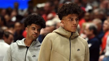 Nov 10, 2023; Durham, North Carolina, USA;  Duke basketball recruits Cayden (left) and Cameron Boozer attend a game between Duke and the Arizona Wildcats at Cameron Indoor Stadium. Mandatory Credit: Rob Kinnan-Imagn Images