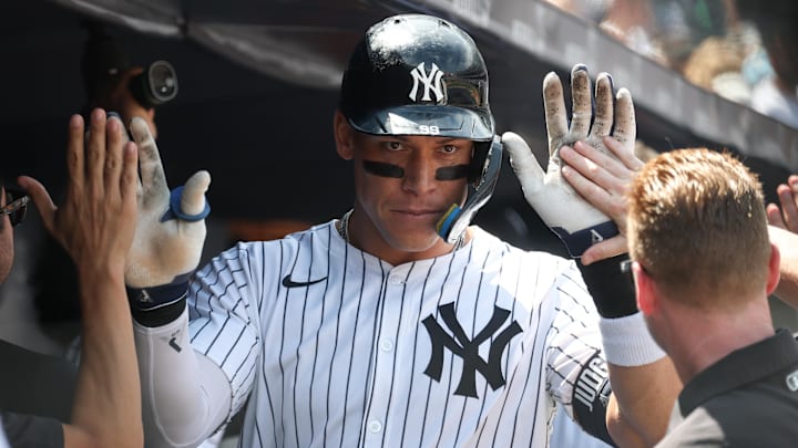 New York Yankees outfielder Aaron Judge (99) celebrates with teammates after hitting a two-run home run against the Athletics at Yankee Stadium. 