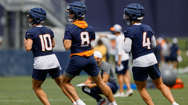 Jul 26, 2024; Englewood, CO, USA; Denver Broncos quarterback Bo Nix (10) and quarterback Jarrett Stidham (8) and quarterback Zach Wilson (4) during training camp at Broncos Park Powered by CommonSpirit. 