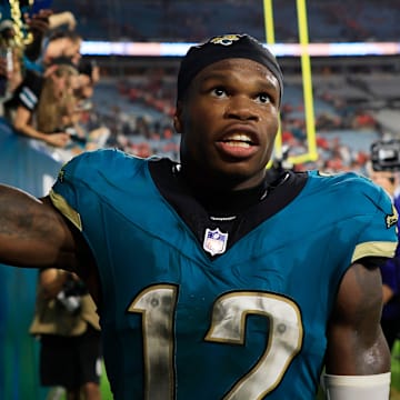 Jacksonville Jaguars wide receiver Travis Hunter (12) high-fives fans after the game of an NFL football matchup at EverBank Stadium, Monday, Oct. 6, 2025, in Jacksonville, Fla. The Jacksonville Jaguars edged the Kansas City Chiefs 31-28. [Corey Perrine/Florida Times-Union]