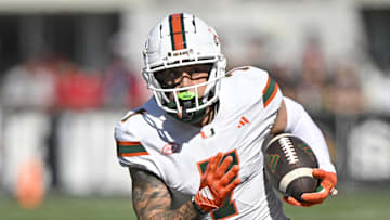 Oct 19, 2024; Louisville, Kentucky, USA;   Miami Hurricanes wide receiver Xavier Restrepo (7) runs the ball against the Louisville Cardinals during the first half at L&N Federal Credit Union Stadium. Miami defeated Louisville 52-45. Mandatory Credit: Jamie Rhodes-Imagn Images