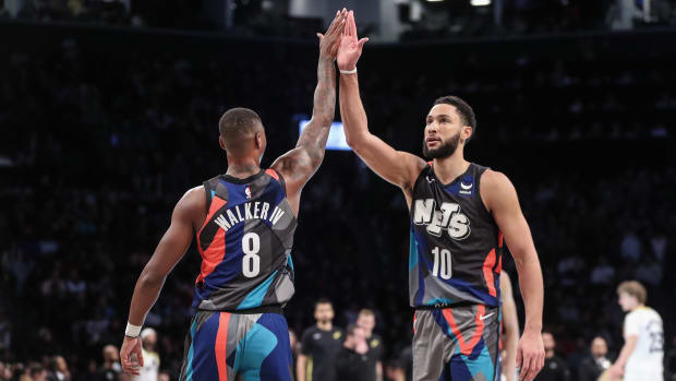 Jan 29, 2024; Brooklyn, New York, USA;  Brooklyn Nets guard Lonnie Walker IV (8) greets guard Ben Simmons (10) during a timeout in the third quarter  against the Utah Jazz at Barclays Center. Mandatory Credit: Wendell Cruz-USA TODAY Sports