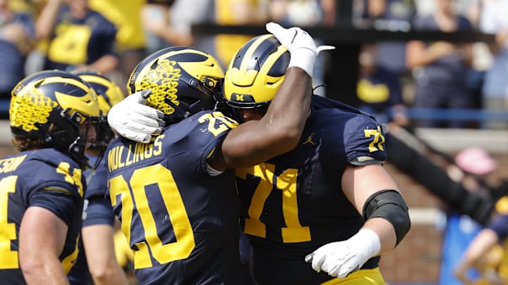 Sep 14, 2024; Ann Arbor, Michigan, USA;  Michigan Wolverines running back Kalel Mullings (20) celebrates with offensive lineman Evan Link (71) after running for a touchdown against the Arkansas State Red Wolves in first half at Michigan Stadium. Mandatory Credit: Rick Osentoski-Imagn Images