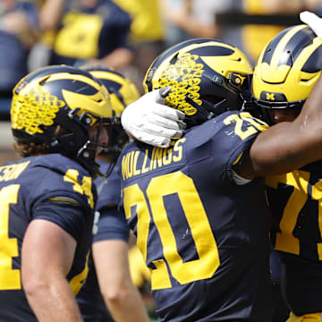 Sep 14, 2024; Ann Arbor, Michigan, USA;  Michigan Wolverines running back Kalel Mullings (20) celebrates with offensive lineman Evan Link (71) after running for a touchdown against the Arkansas State Red Wolves in first half at Michigan Stadium. Mandatory Credit: Rick Osentoski-Imagn Images