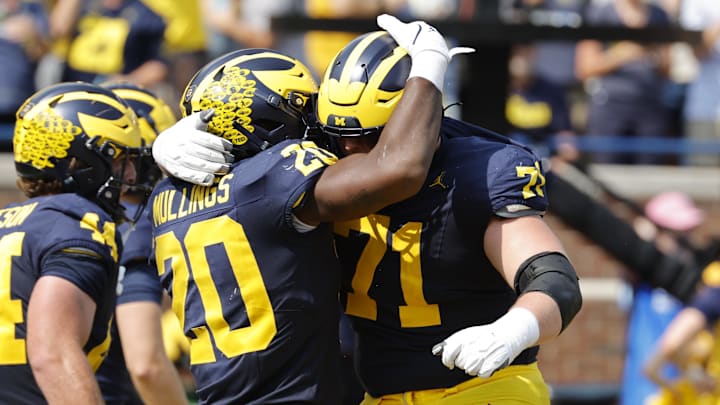 Sep 14, 2024; Ann Arbor, Michigan, USA;  Michigan Wolverines running back Kalel Mullings (20) celebrates with offensive lineman Evan Link (71) after running for a touchdown against the Arkansas State Red Wolves in first half at Michigan Stadium. Mandatory Credit: Rick Osentoski-Imagn Images