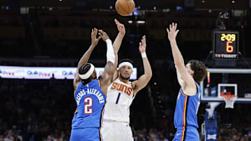 Apr 2, 2023; Oklahoma City, Oklahoma, USA; Phoenix Suns guard Devin Booker (1) passes the ball between Oklahoma City Thunder guard Shai Gilgeous-Alexander (2) and guard Josh Giddey (3) during the second half at Paycom Center. Phoenix won 128-118. Mandatory Credit: Alonzo Adams-Imagn Images