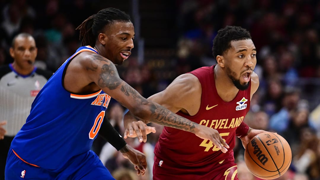 Apr 2, 2025; Cleveland, Ohio, USA; Cleveland Cavaliers guard Donovan Mitchell (45) drives to the basket against New York Knicks guard Delon Wright (0) during the second half at Rocket Arena. Mandatory Credit: Ken Blaze-Imagn Images