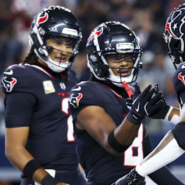 Nov 18, 2024; Arlington, Texas, USA;  Houston Texans running back Joe Mixon (28) celebrates with Houston Texans wide receiver John Metchie III (8) after scoring a touchdown  during the first quarter against the Dallas Cowboys at AT&T Stadium. Mandatory Credit: Kevin Jairaj-Imagn Images