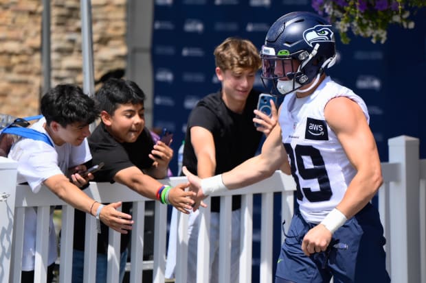 Seattle Seahawks safety Ty Okada (39) interacts with fans prior to training camp at the Virginia Mason Athletic Center.